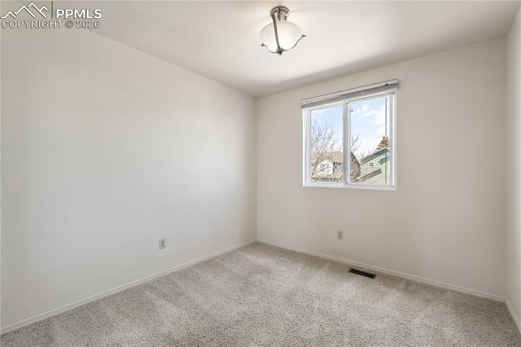 Image 26 of 43: Warm and inviting living room, large bright windows, carpet throughout, eas