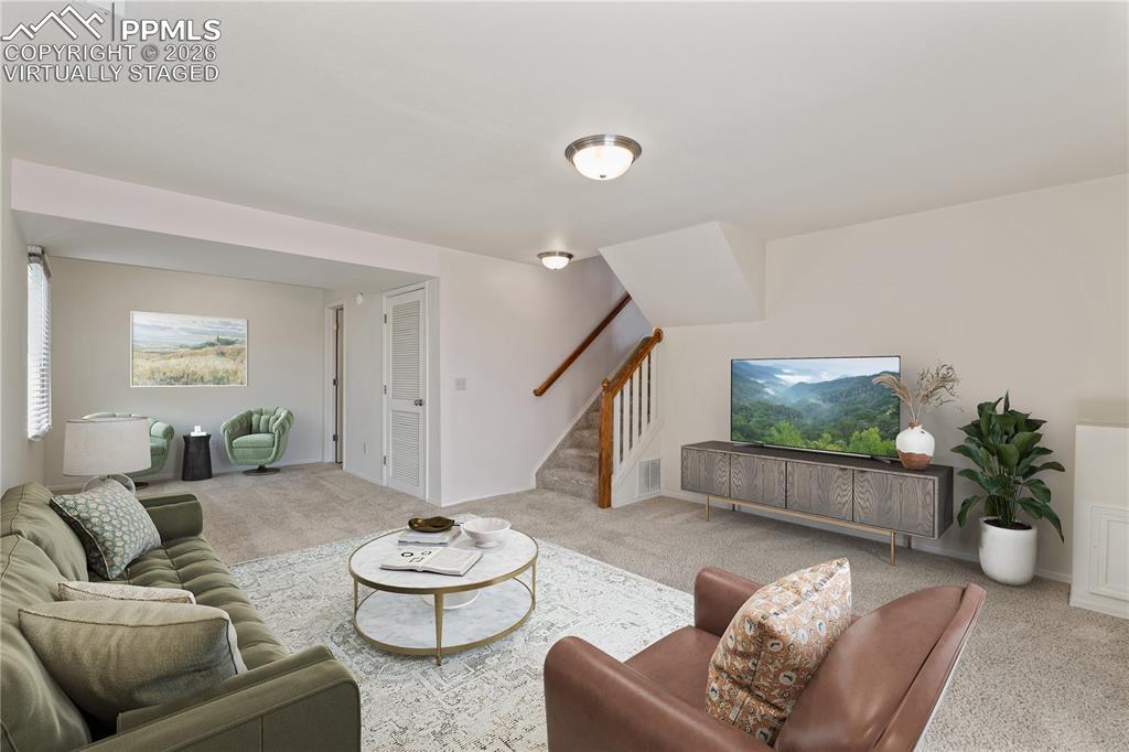 Image 30 of 43: Bright, warm and inviting, ceiling fan, carpet throughout