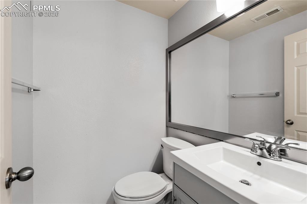 Image 31 of 43: Primary Bedroom, carpet throughout, ceiling fan, closet space and bathroom 