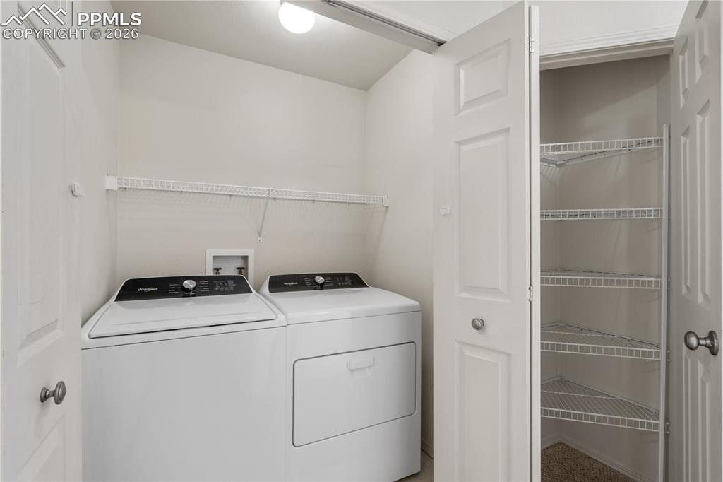Image 32 of 43: Primary bathroom with tile shower surround, glass shower door, single vanit