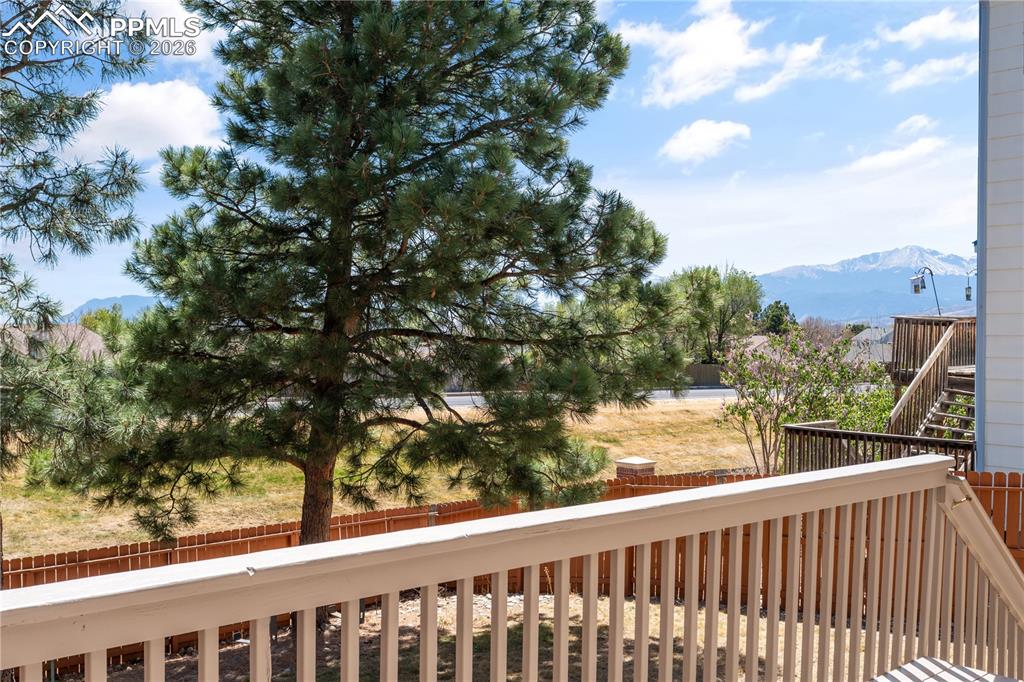 Image 35 of 43: Bathroom with tile shower surround, single vanity, and large mirror