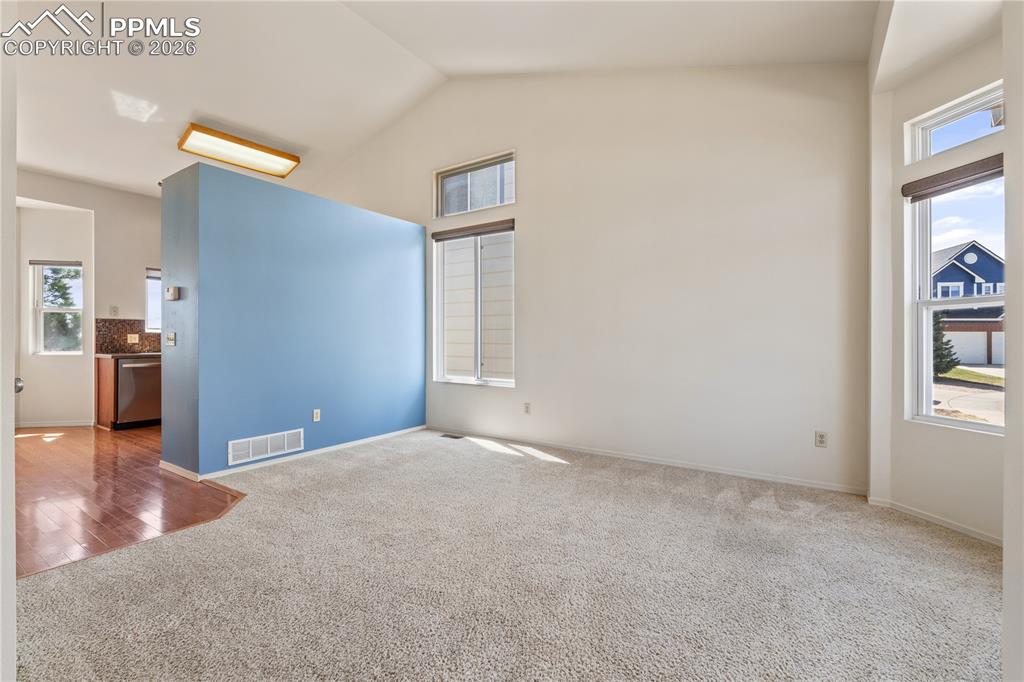 Image 5 of 43: Inviting entry with bright lighting, tile flooring at entry, carpet through