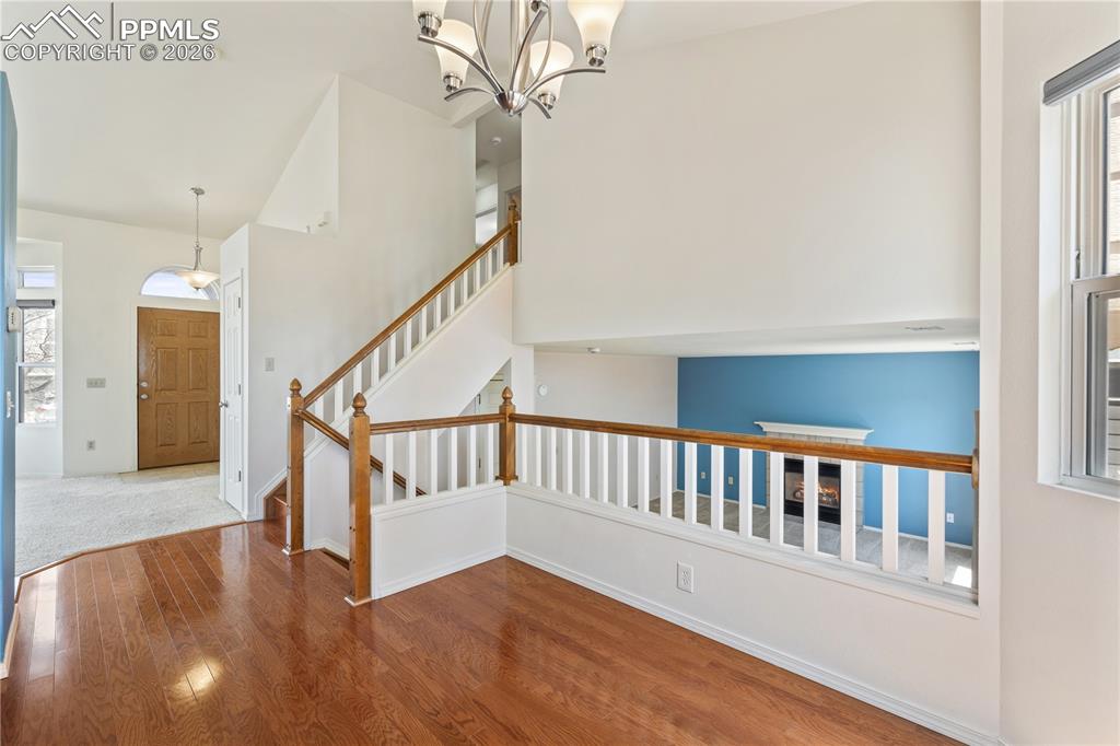 Image 9 of 43: Inviting entry with bright lighting, tile flooring at entry, carpet through