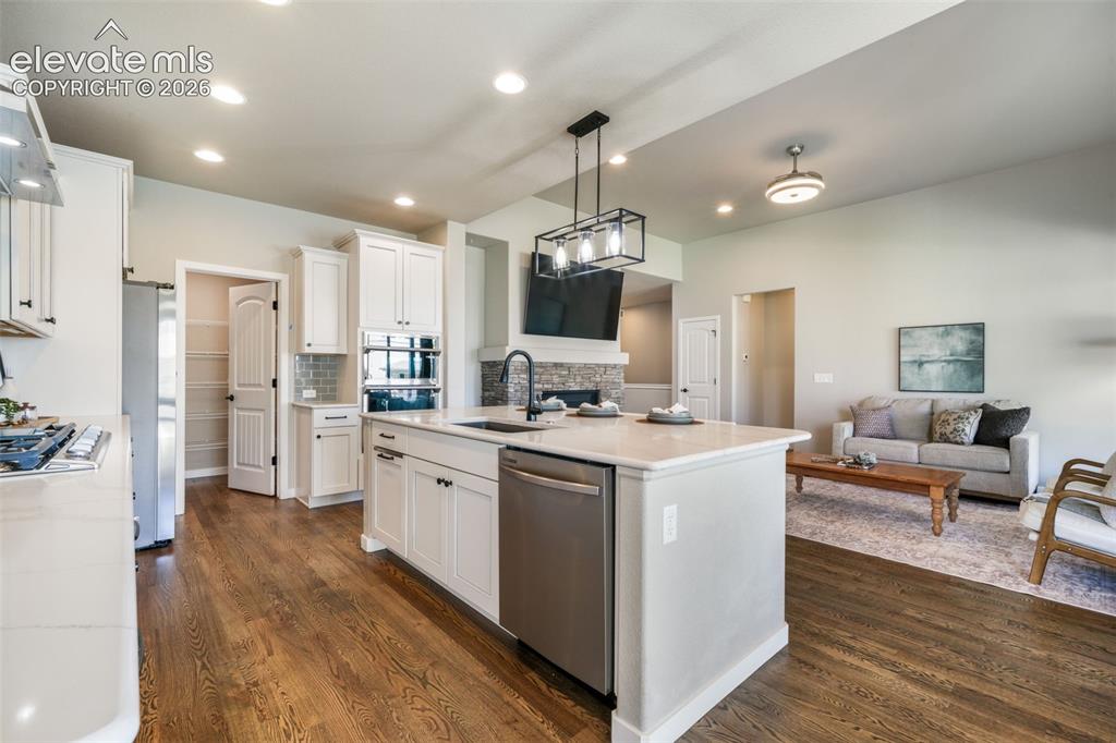 Image 17 of 50: Walk-in pantry, custom lighting, downdraft, gas cooktop, wall unit microwav