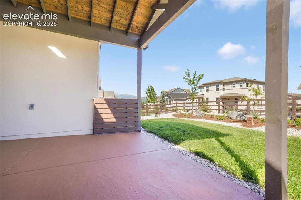 Image 44 of 50: Custom Covered patio, with stamped concrete, views of Pikes Peak