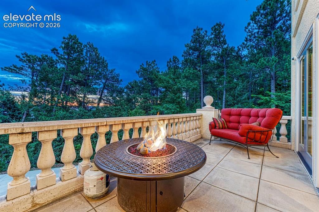 Image 10 of 44: Expansive outdoor patio featuring a checkerboard-patterned surface, a built