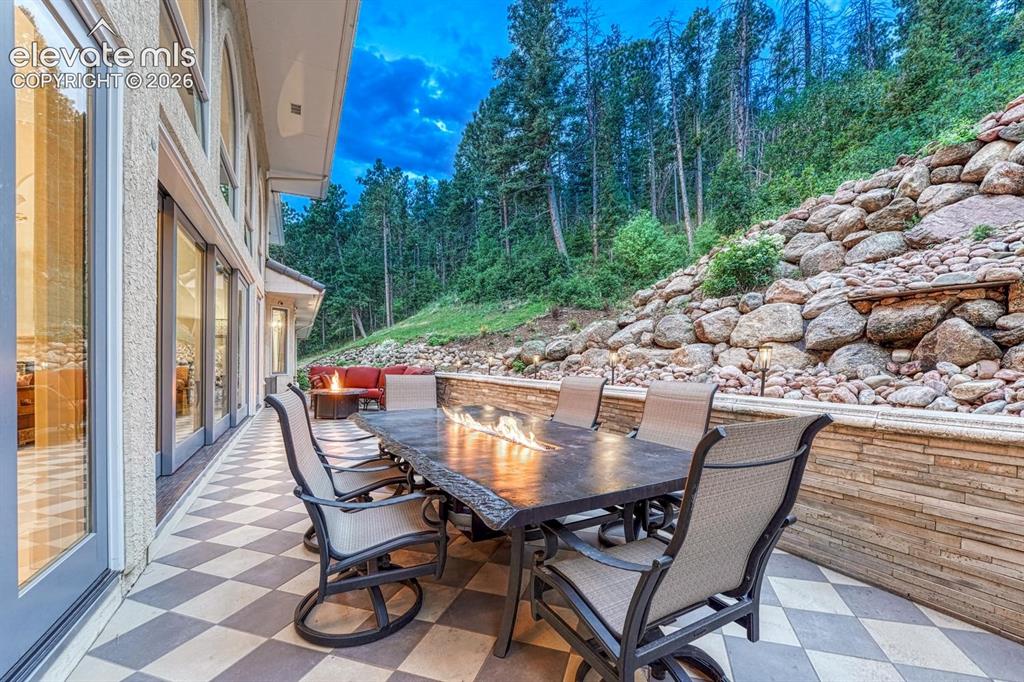 Image 7 of 44: Two-story living area featuring wood-finish flooring and a white mantel fir