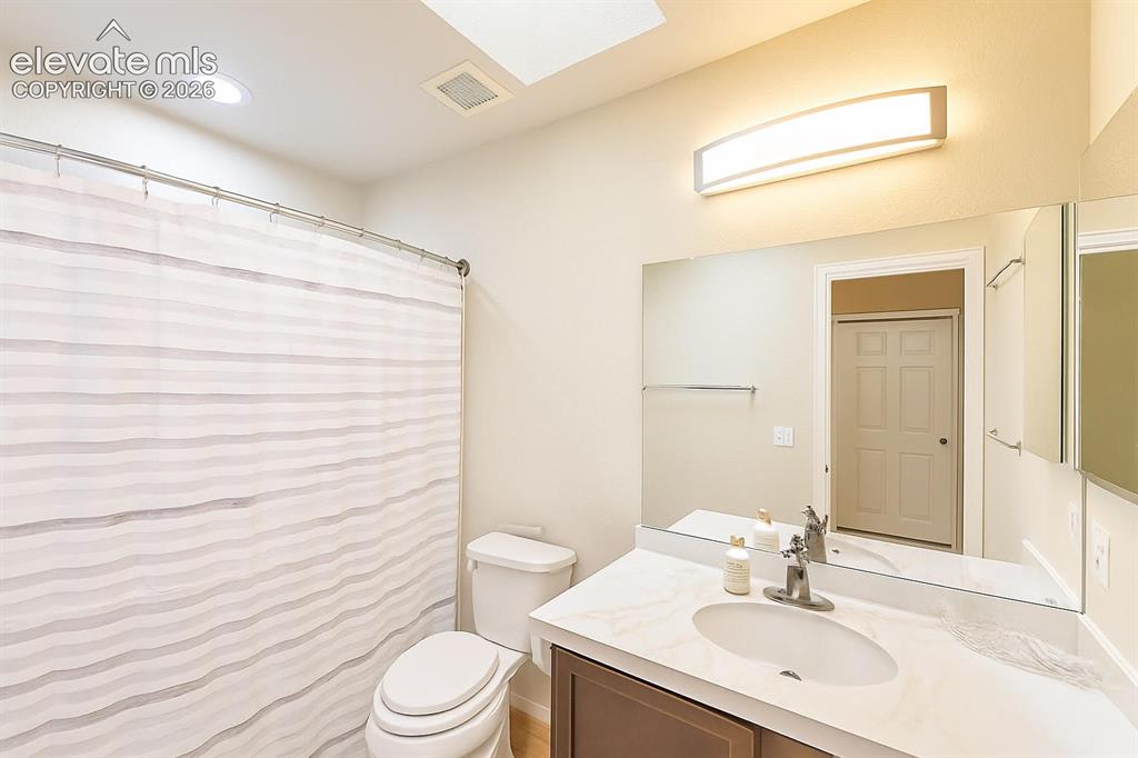 Image 7 of 15: Vanity with an integrated sink, polished chrome faucet, and expansive wall-
