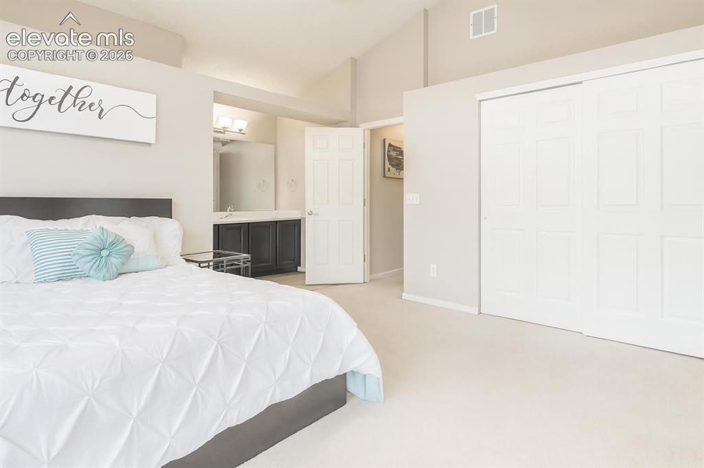Image 8 of 15: Vaulted ceiling, plush carpeting, built-in closet with sliding doors, dark 