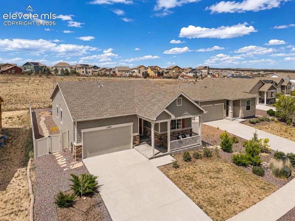 Image 1 of 38: Contemporary home featuring a covered front porch, an attached two-car gara