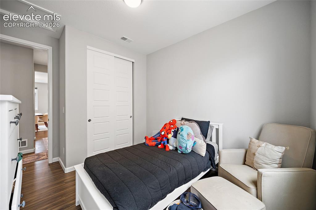 Image 15 of 38: Recessed lighting illuminating wood-finish flooring