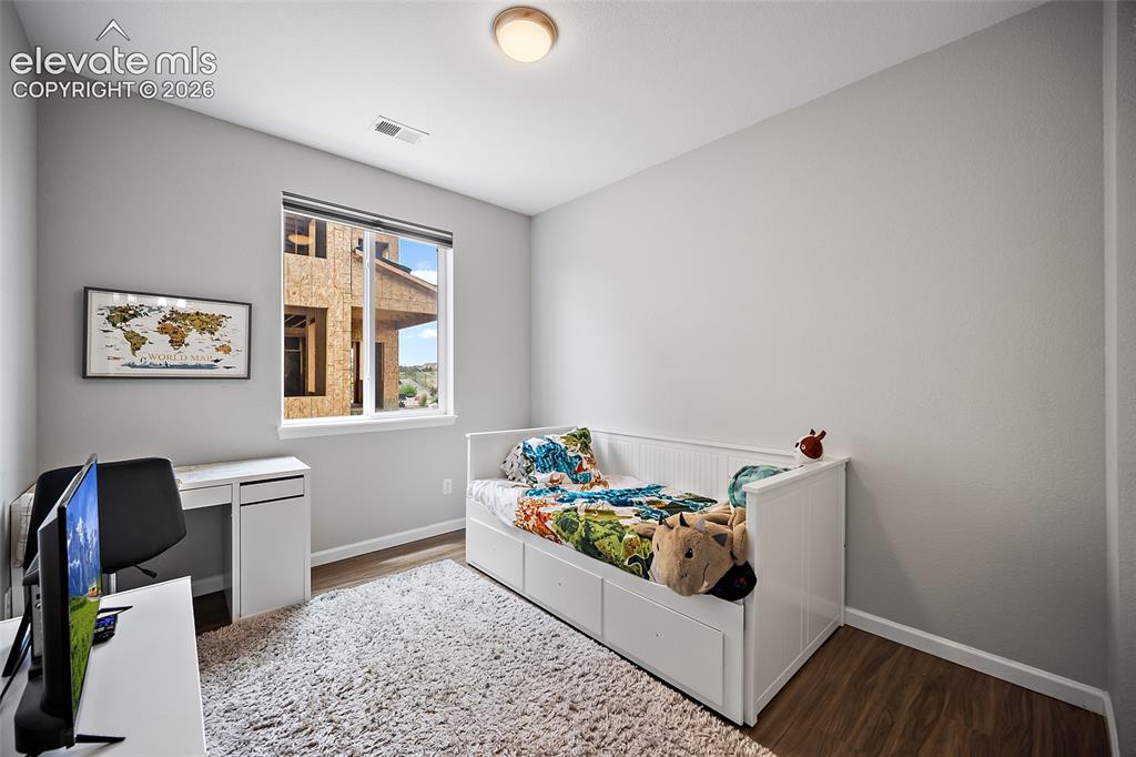 Image 16 of 38: Light gray wall color with wood-finish flooring