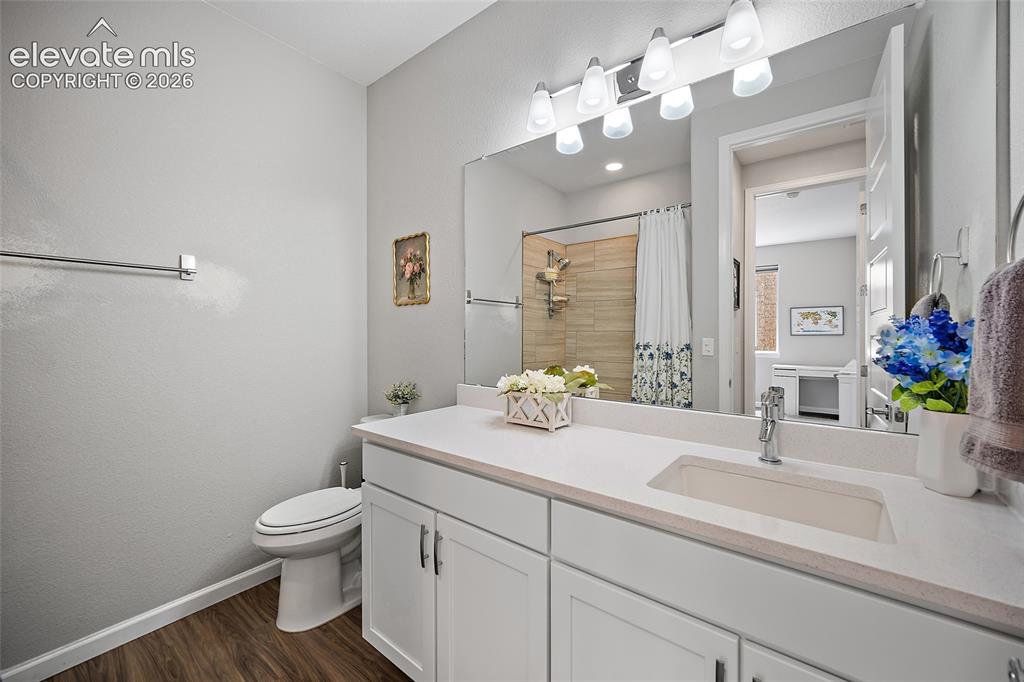 Image 18 of 38: Bathroom featuring a white vanity with integrated sink, white countertop, c