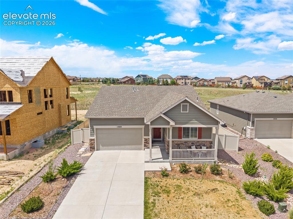 Image 28 of 38: Single-story residence featuring a covered front porch, an attached garage,
