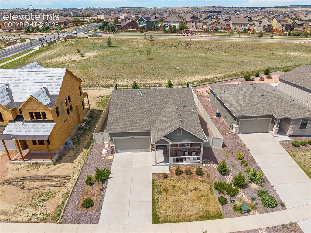 Image 30 of 38: Single-story residence featuring a covered front porch, an attached two-car