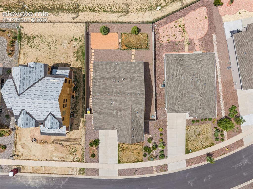 Image 31 of 38: Aerial view showcasing a residential property with a shingle roof and concr