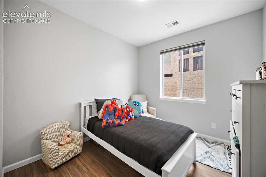 Image 33 of 38: Light gray walls with white trim and wood-finish flooring