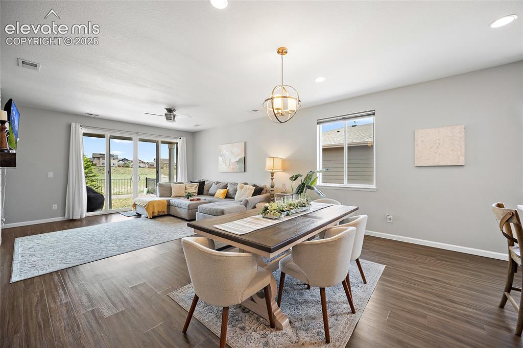 Image 9 of 38: Open-concept living area featuring wood-finish flooring, recessed lighting,