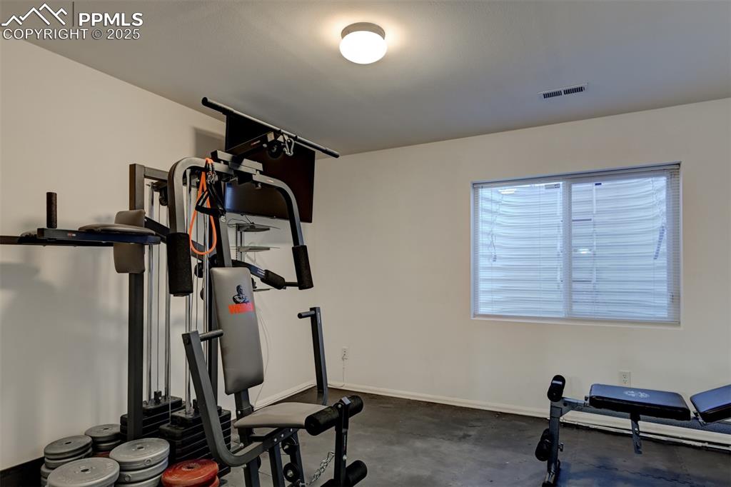 Image 41 of 47: Exercise Room with matted flooring, and space for a closet.