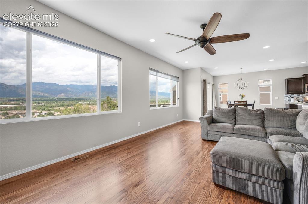 Image 12 of 34: Open concept living area featuring expansive windows with a dramatic front