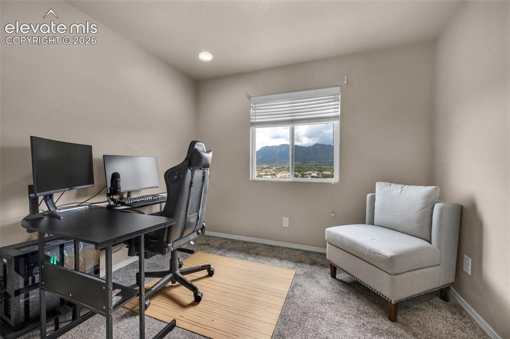Image 18 of 34: Bedroom #2 is currently being used as an office. Neutral tone wall paint an