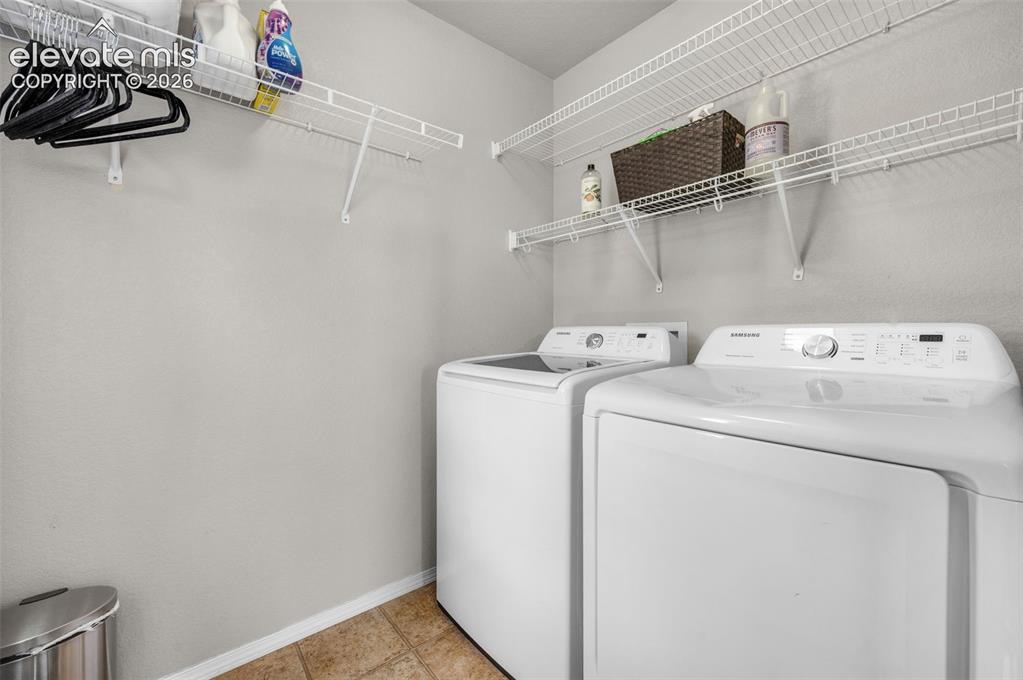 Image 21 of 34: Dedicated laundry on the upper floor featuring wire shelving, neutral wall