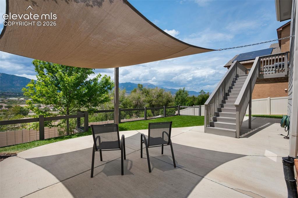 Image 28 of 34: Outdoor patio area featuring a shade sail and concrete surface