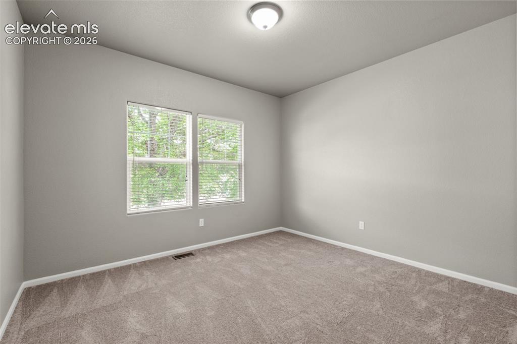 Image 10 of 20: Neutral interior room featuring neutral wall paint, plush carpeting, dual-p