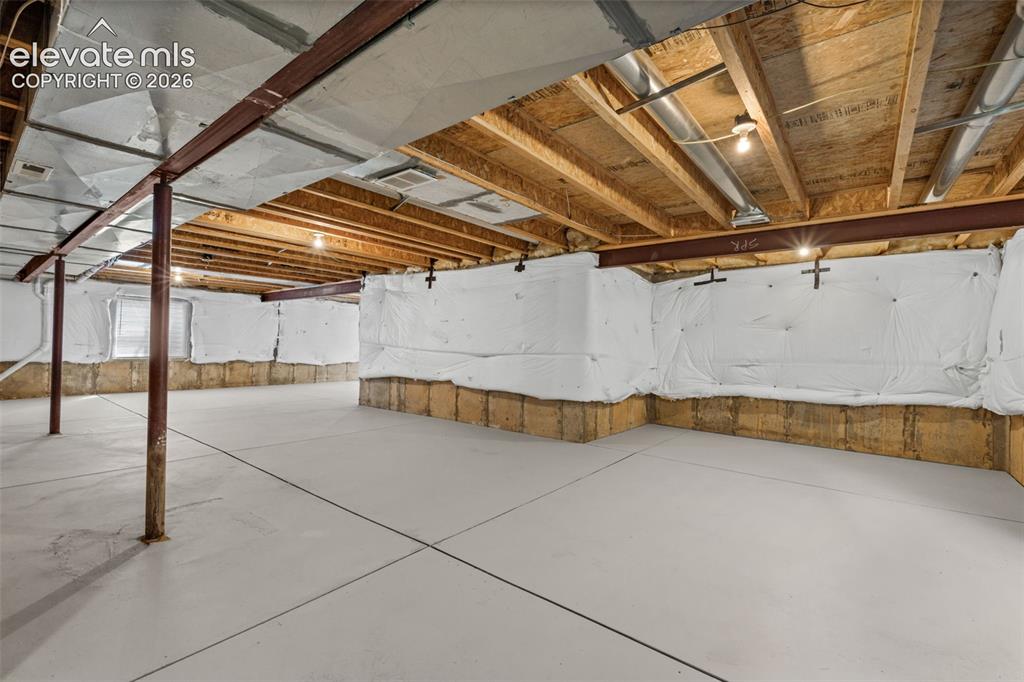 Image 13 of 20: Unfinished lower level featuring smooth concrete flooring, exposed wood cei