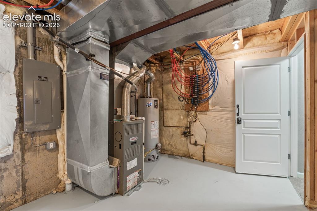 Image 14 of 20: Mechanical utility area featuring a Lennox gas furnace, water heater, elect