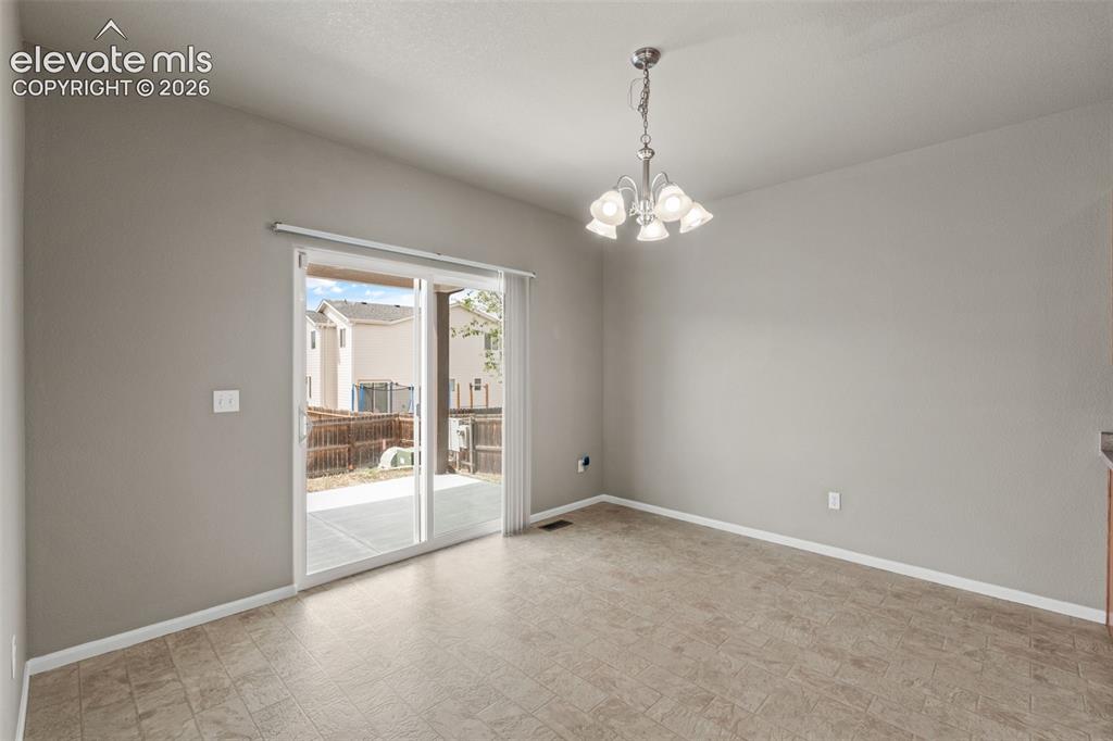 Image 4 of 20: Interior area featuring neutral wall paint, tile flooring, a multi-arm chan