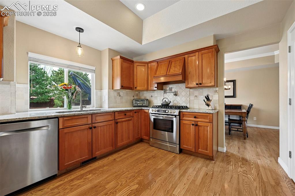 Image 13 of 44: Fully redesigned kitchen with improved flow, granite counters, and expanded
