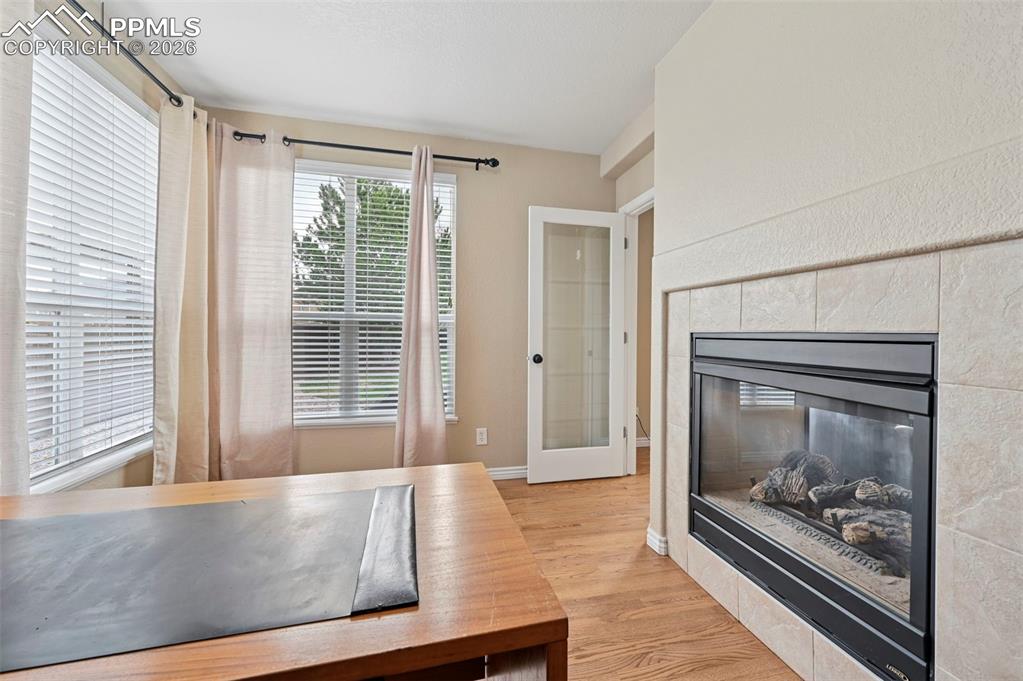 Image 19 of 44: See-through fireplace creates a cozy focal point between living spaces