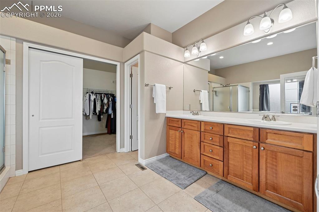Image 26 of 44: Primary bath with double vanities and functional layout