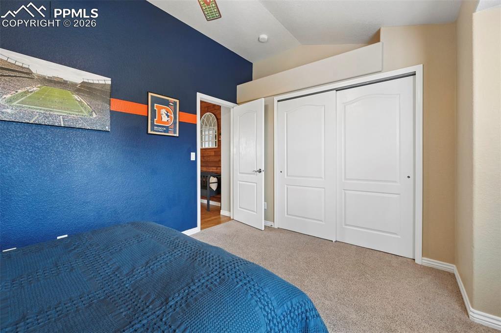 Image 30 of 44: Comfortable 2nd bedroom with space for guests, family, or office setup