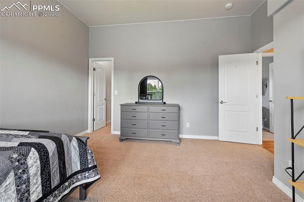 Image 32 of 44: Well-sized 3rd bedroom ideal for family, guests, or work-from-home needs