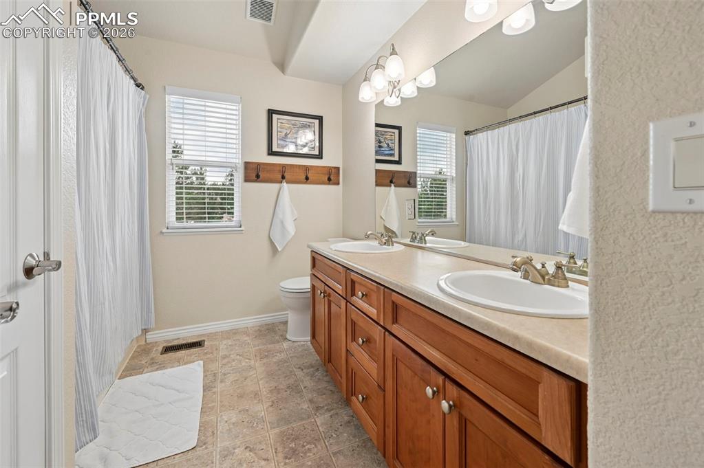 Image 33 of 44: Secondary bath with functional layout and clean finishes
