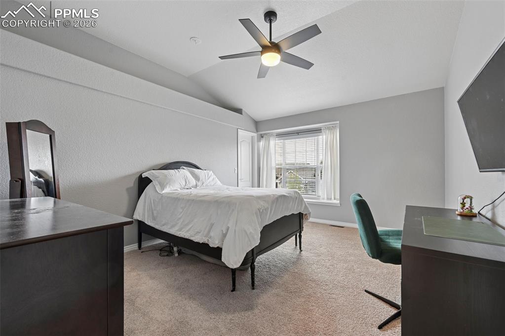 Image 34 of 44: Spacious 4th upper-level bedroom with vaulted ceiling and open feel
