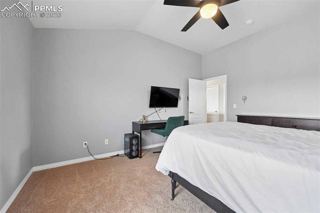 Image 35 of 44: Spacious 4th upper-level bedroom with vaulted ceiling and open feel