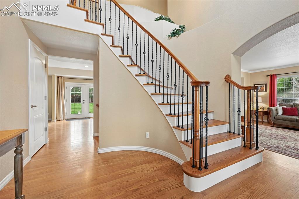 Image 6 of 44: Striking staircase creates a grand first impression and central focal point