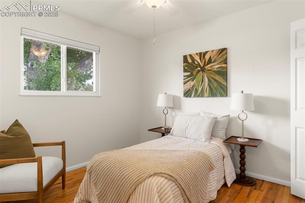 Image 13 of 30: Bedroom featuring wood finished floors and ceiling fan