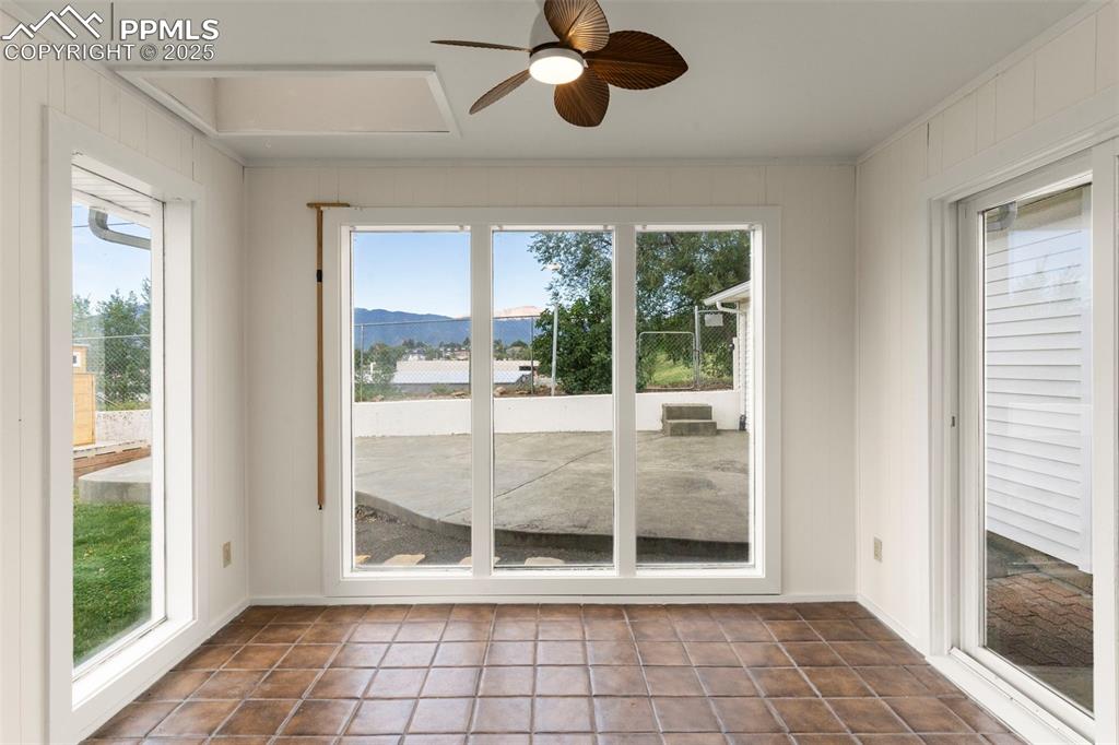 Image 16 of 30: Unfurnished sunroom with a mountain view and tile patterned flooring