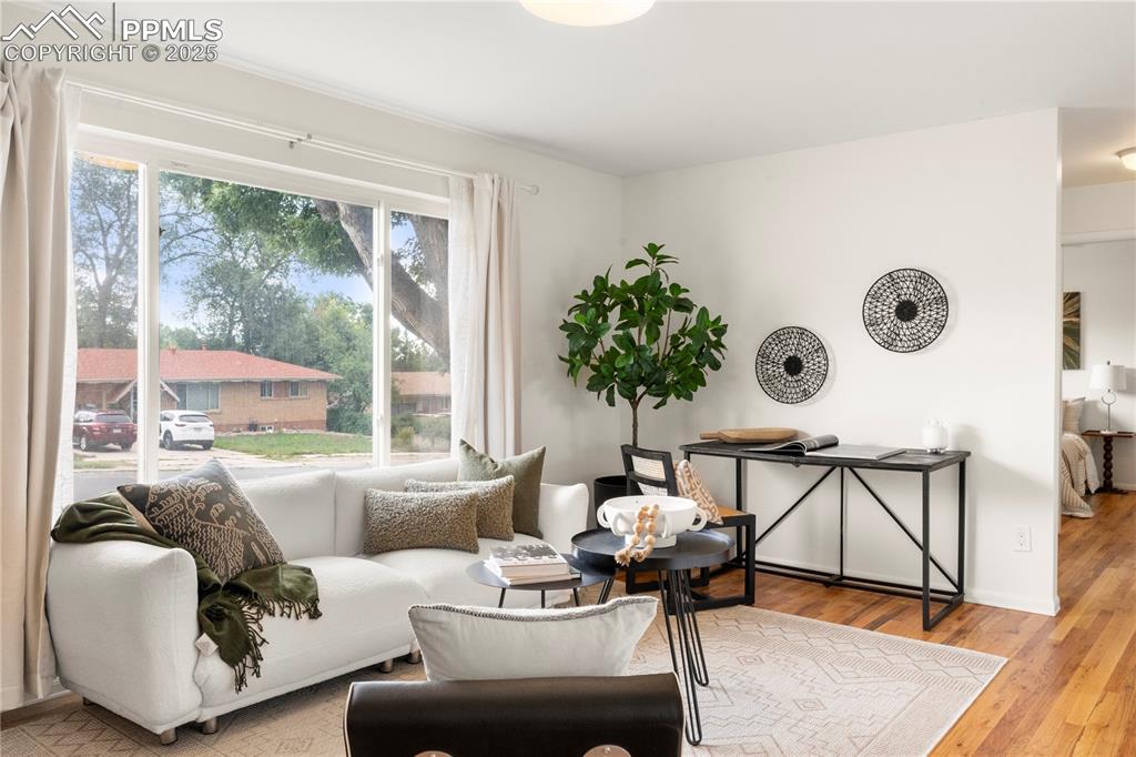 Image 3 of 30: Living area featuring light wood-style floors and baseboards