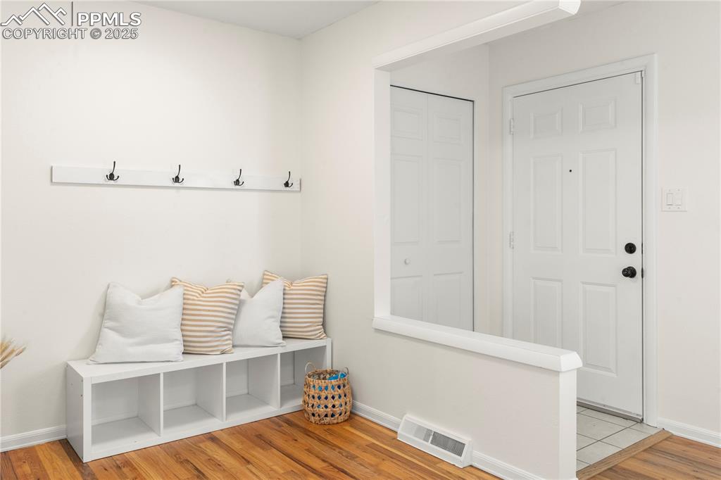 Image 5 of 30: Mudroom featuring baseboards and light wood-type flooring