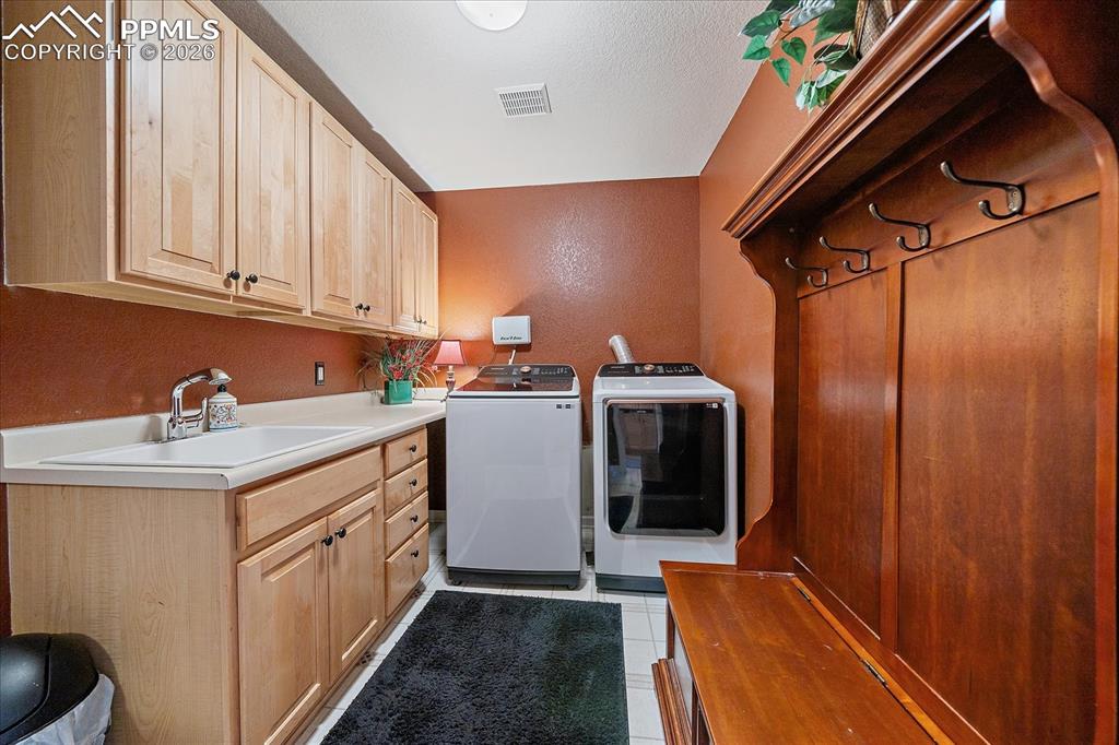 Image 14 of 50: Laundry Room with ample cabinet space, sink, washer and dryer included