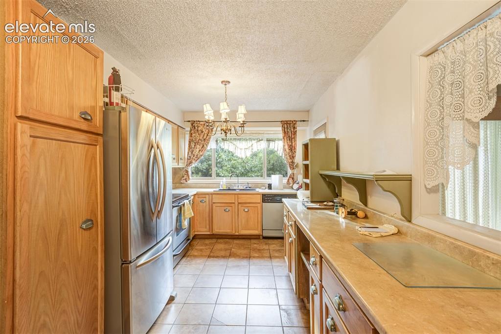 Image 3 of 11: Kitchen with stainless steel appliances. 