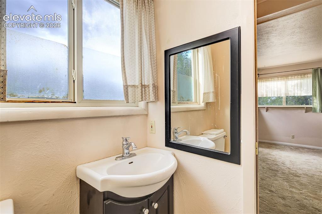 Image 9 of 11: Bedroom 3 with an attached bathroom with a standing shower