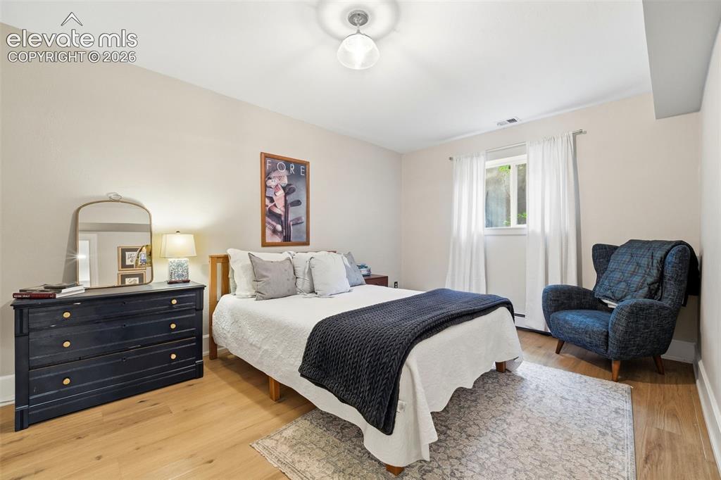 Image 33 of 50: Basement bedroom, with very large storage area attached