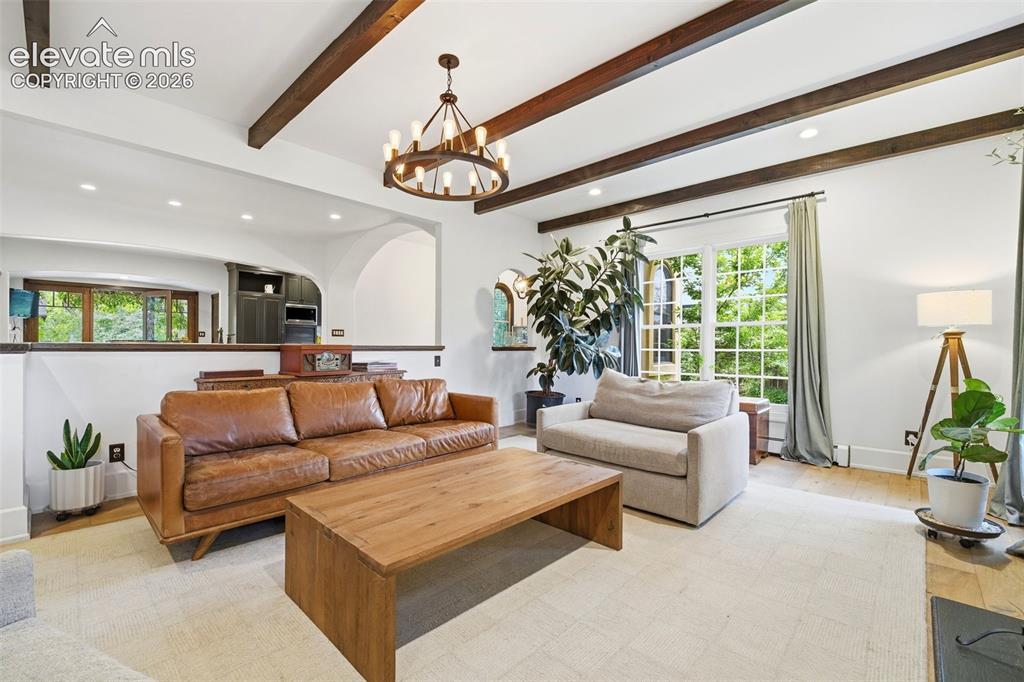 Image 8 of 50: Living area featuring exposed ceiling beams and recessed lighting