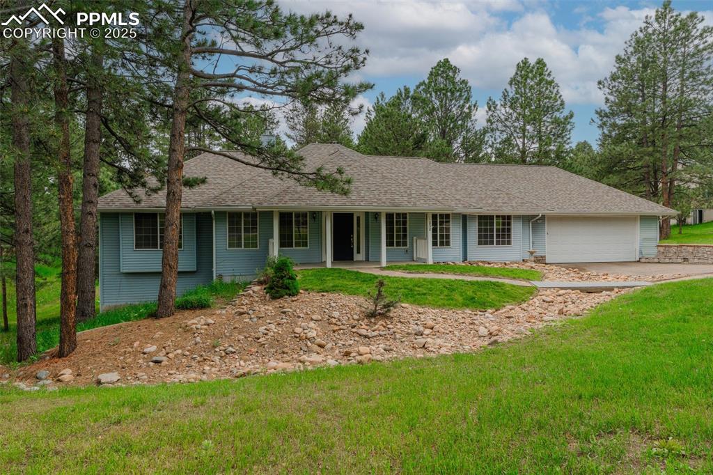 Image 3 of 31: Ranch-style home featuring roof with shingles, a front lawn, and driveway